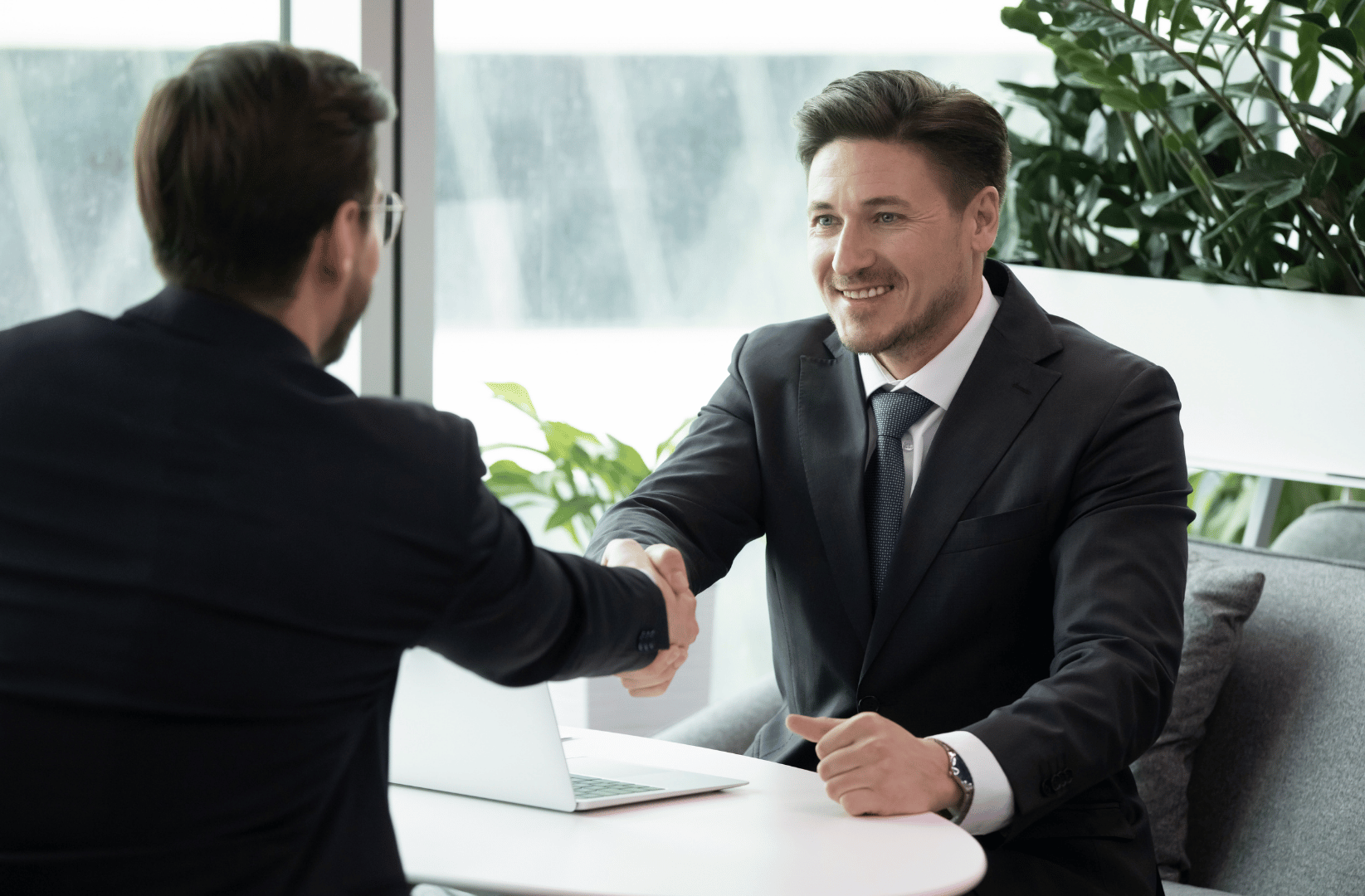 Fortis Insurance agent shaking hands with a client after comparing quotes